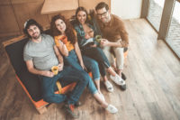 Carefree friends entertaining in living room